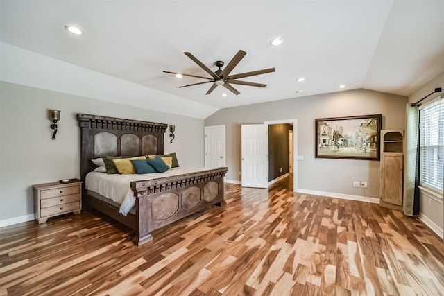 bedroom featuring ceiling fan, wood-type flooring, and vaulted ceiling