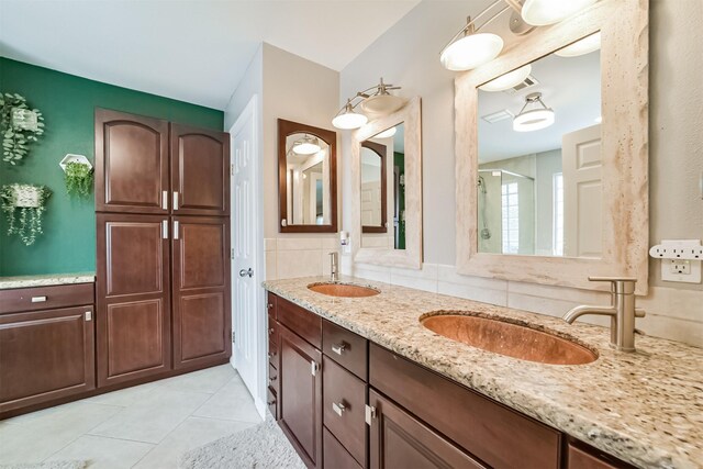 bathroom featuring tasteful backsplash, vanity, an enclosed shower, and tile patterned flooring