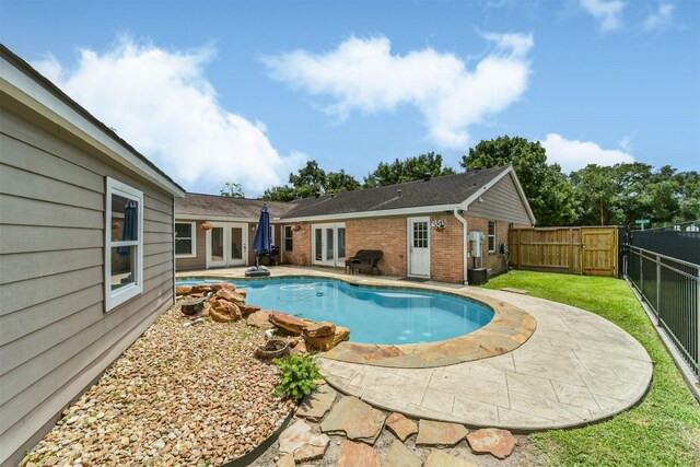 view of pool featuring a patio area and french doors