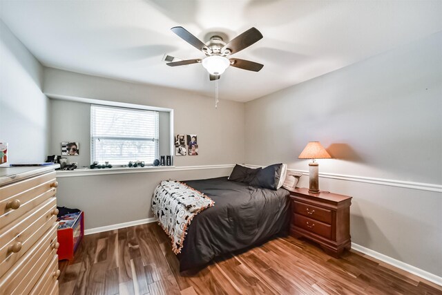 bedroom with ceiling fan and dark hardwood / wood-style flooring