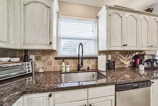 kitchen featuring sink, decorative backsplash, dark stone counters, and dishwasher