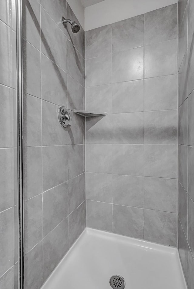 bathroom with a tile shower