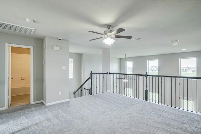 carpeted empty room with ceiling fan