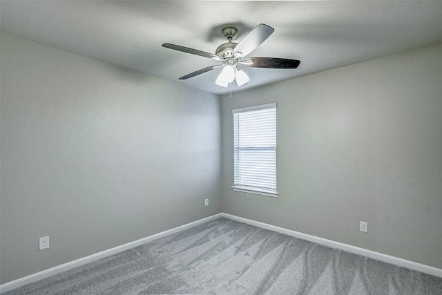 empty room with ceiling fan and carpet