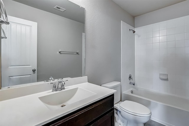 full bathroom with tiled shower / bath combo, vanity, and toilet