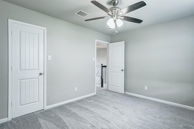 unfurnished bedroom featuring light colored carpet and ceiling fan