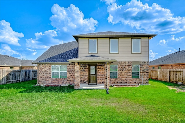 rear view of house with a lawn