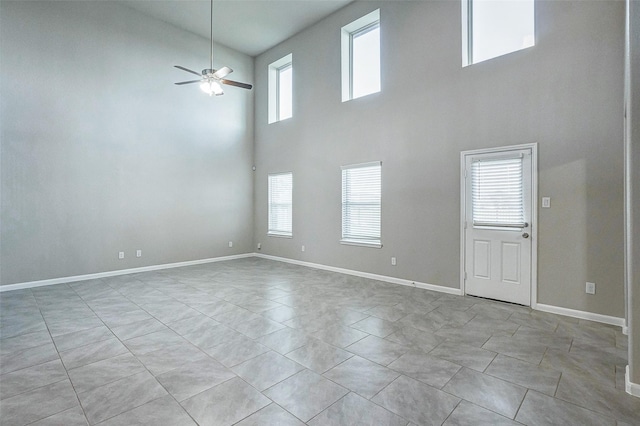 interior space with ceiling fan, a healthy amount of sunlight, and light tile patterned floors