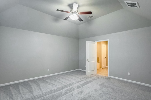 interior space featuring lofted ceiling, light colored carpet, and ceiling fan