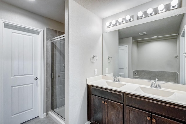 bathroom featuring vanity and a shower with door