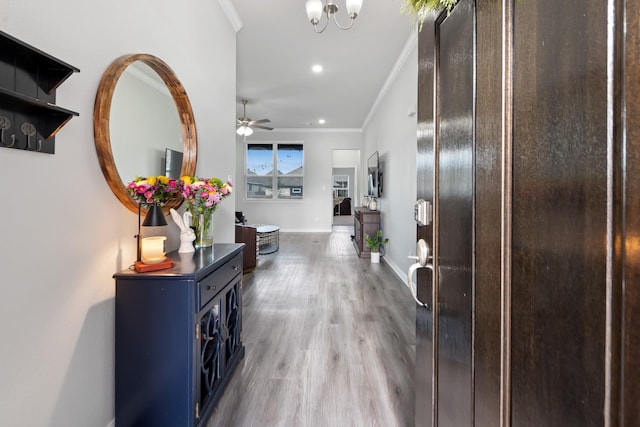 hallway with crown molding and light hardwood / wood-style floors