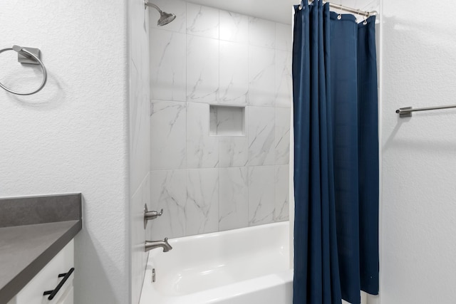 bathroom with shower / tub combo and vanity