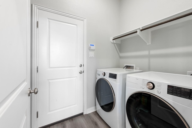 laundry room featuring hardwood / wood-style flooring and washer and clothes dryer