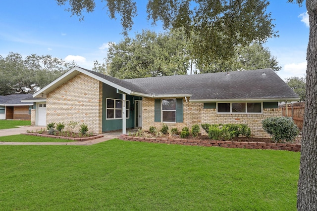 ranch-style home with a garage and a front lawn