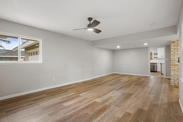 unfurnished living room featuring ceiling fan and light hardwood / wood-style flooring