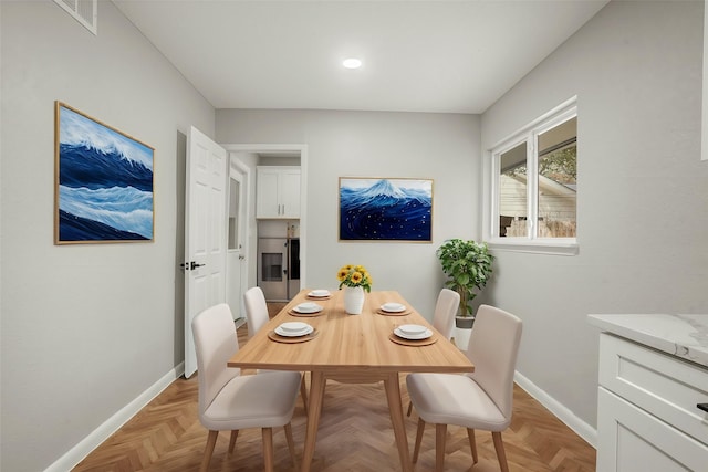 dining room featuring visible vents and baseboards