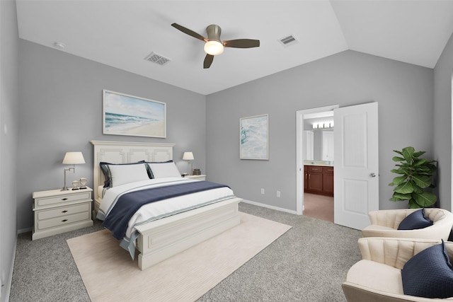 bedroom with carpet floors, connected bathroom, vaulted ceiling, and ceiling fan