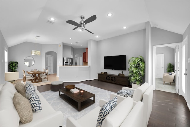 living room with hardwood / wood-style flooring, vaulted ceiling, and ceiling fan