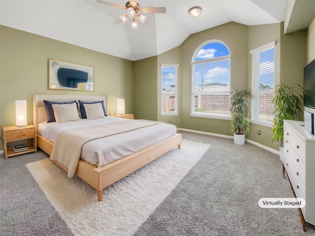 carpeted bedroom featuring lofted ceiling and ceiling fan