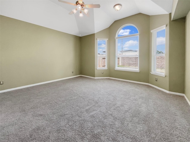 empty room featuring ceiling fan, lofted ceiling, and carpet floors