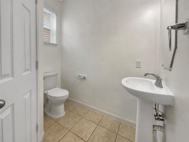 bathroom with toilet and tile patterned flooring