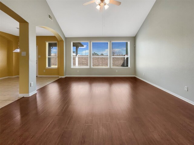 unfurnished room featuring wood-type flooring, high vaulted ceiling, and ceiling fan