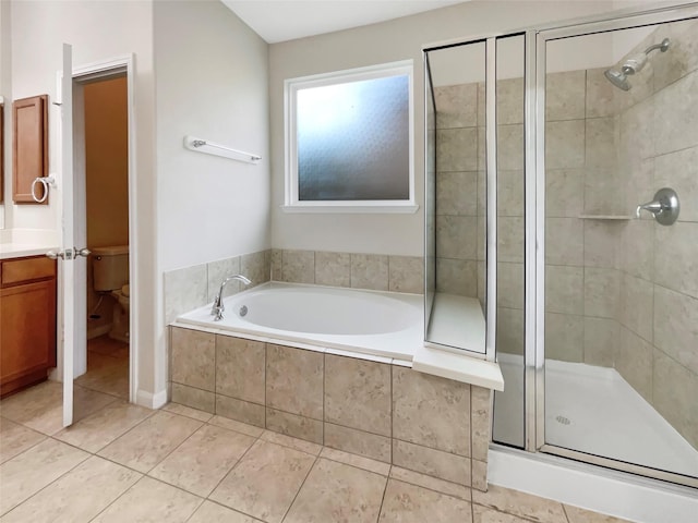 bathroom with tile patterned floors and separate shower and tub