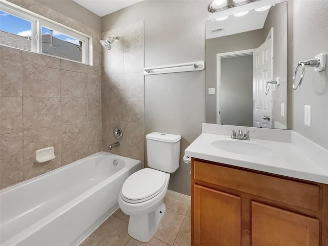 full bathroom with vanity, toilet, tiled shower / bath combo, and tile patterned flooring