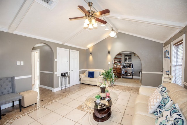 living room featuring vaulted ceiling with beams, light tile patterned floors, and ceiling fan