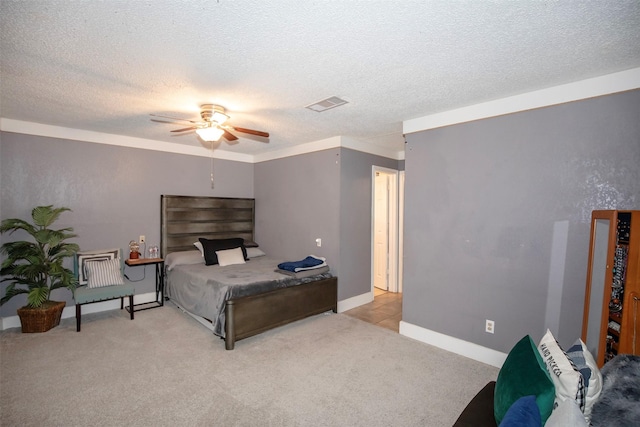 carpeted bedroom featuring ceiling fan and a textured ceiling