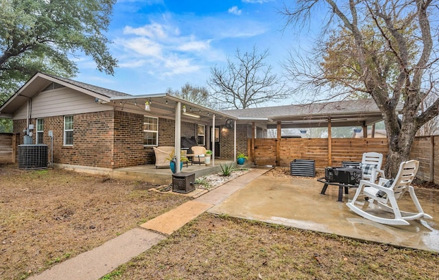 back of property with central AC and a patio area