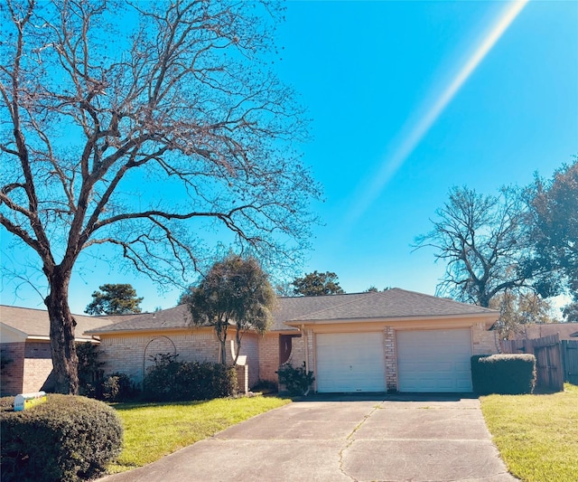 ranch-style home with brick siding, an attached garage, fence, and a front yard