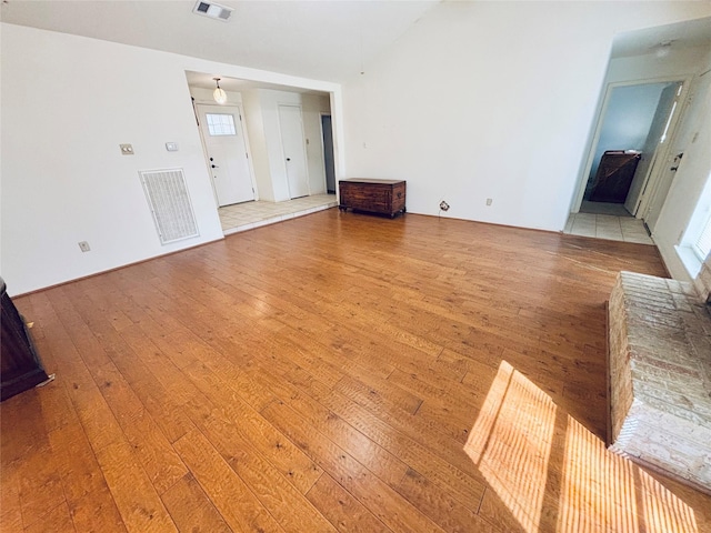 unfurnished living room with light wood-type flooring and visible vents