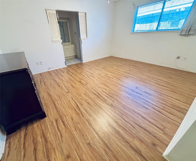 unfurnished room with light wood finished floors