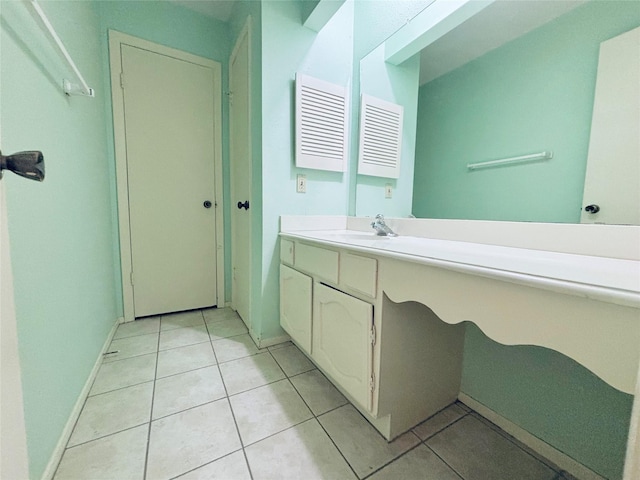 bathroom featuring vanity, baseboards, and tile patterned floors