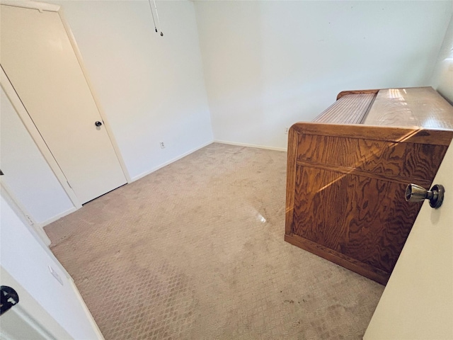 bedroom featuring baseboards and light colored carpet