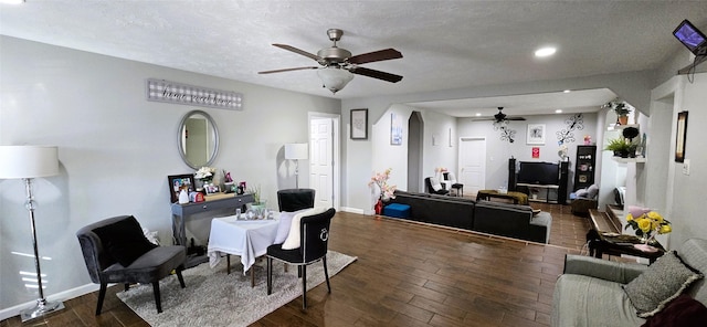 dining space featuring ceiling fan, dark hardwood / wood-style floors, and a textured ceiling