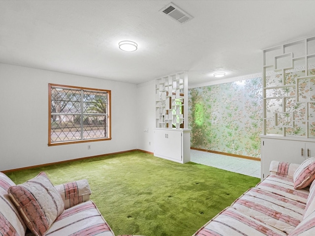 living area featuring wallpapered walls, carpet, visible vents, and baseboards