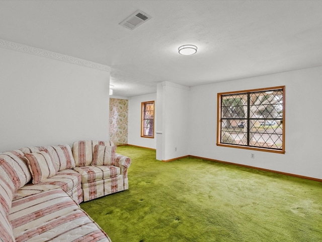 living area with carpet flooring, visible vents, and baseboards