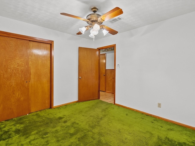 unfurnished bedroom featuring a closet, visible vents, light carpet, and baseboards