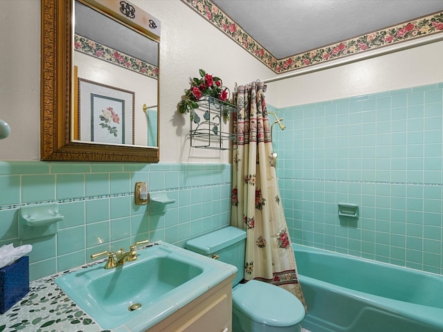 full bathroom featuring a textured ceiling, toilet, vanity, tile walls, and shower / bath combination with curtain