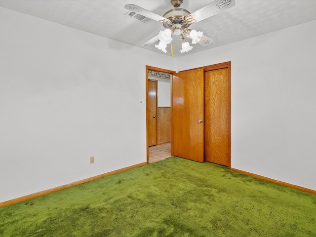 unfurnished bedroom featuring visible vents, baseboards, a ceiling fan, light colored carpet, and a closet