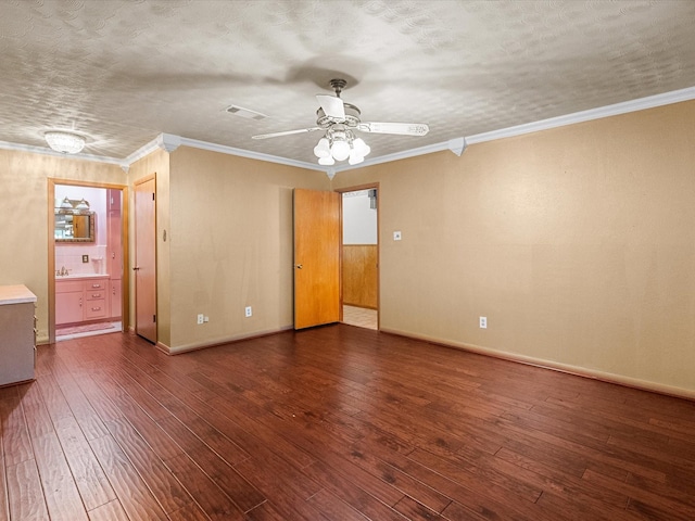 spare room with visible vents, crown molding, a textured ceiling, and hardwood / wood-style floors