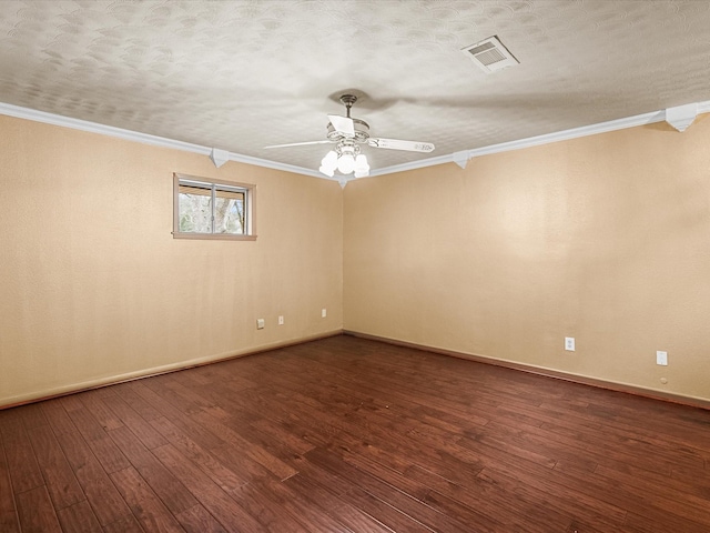 empty room with dark wood-style floors, visible vents, ornamental molding, and a textured ceiling