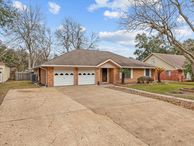 ranch-style house with an attached garage, central AC, brick siding, concrete driveway, and a front lawn