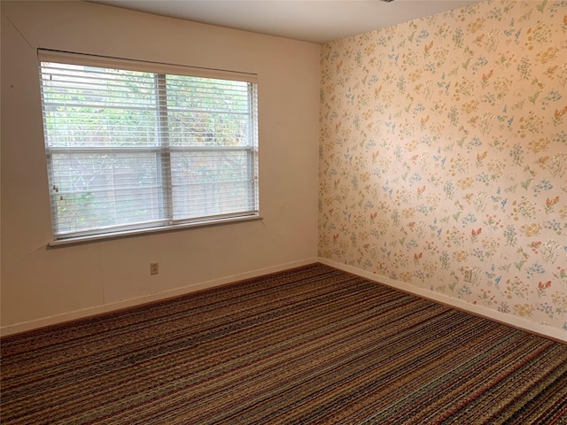 empty room featuring dark colored carpet