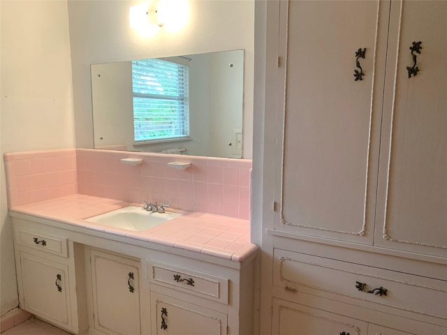 bathroom with vanity and decorative backsplash