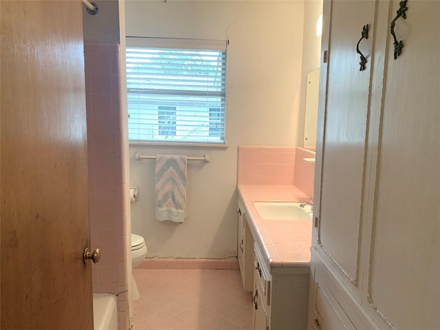 bathroom with vanity, tile patterned flooring, and toilet