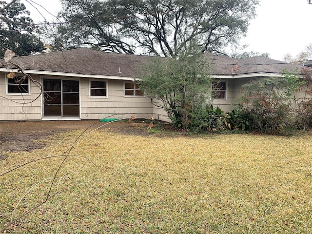 back of property featuring a lawn