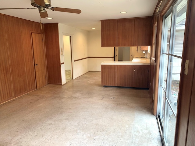 kitchen featuring ceiling fan and kitchen peninsula